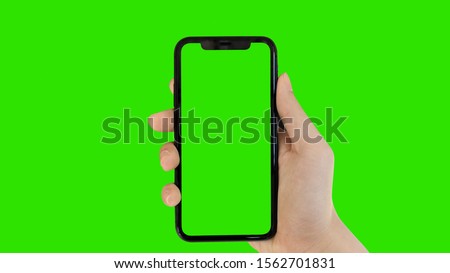 man's hand holding phone a mobile telephone with a vertical green screen in tram chroma key smartphone technology cell phone touch message display hand with luma white and black key