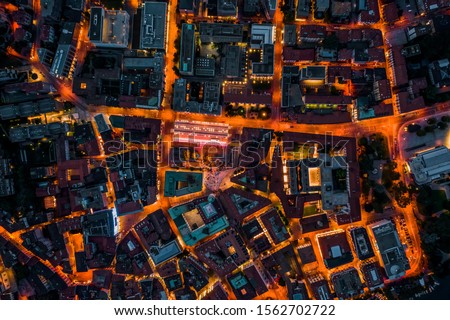 Overhead aerial drone night shot of city street lights in Lugano, Switzerland