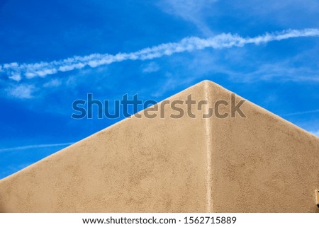 A pueblo style house corner on a blue sky