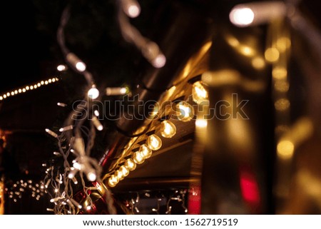 Close up photo of yellow christmas lights on market stall in Poznan, Poland during traditional Christmas Market.