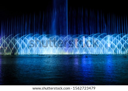 Music fountain on the water at night