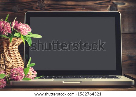 Open laptop with blank screen and wildflower vase - template for design with place for text, mocap with paths for cutting
