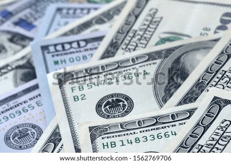 Abstract textured backdrop with many hundred dollar bills