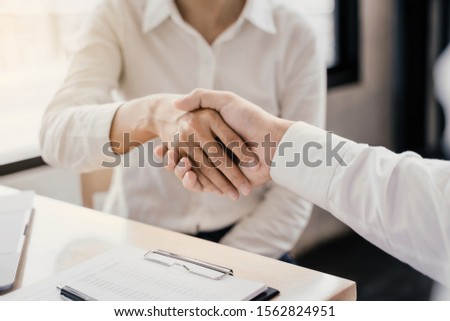 Business partnership hand shaking successful commerce dealing. 