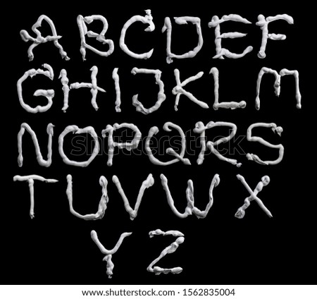 set of latin letters. white oil paint on a black background.
