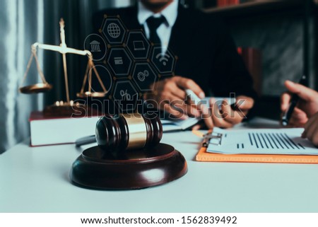 Law and Legal services concept. lawyer judge or Auction show gavel in the office with law interface icons.