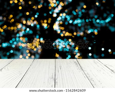 Natural wooden table on a light bokeh background is used for editing trade shows. Business concepts