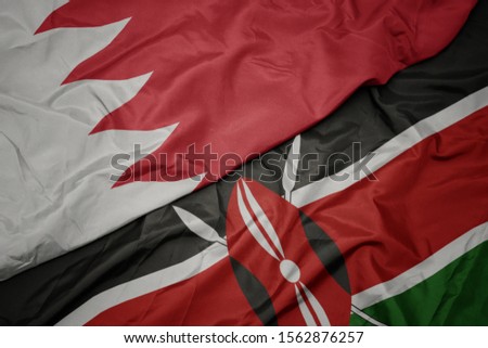 waving colorful flag of kenya and national flag of bahrain. macro