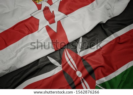 waving colorful flag of kenya and national flag of northern ireland. macro