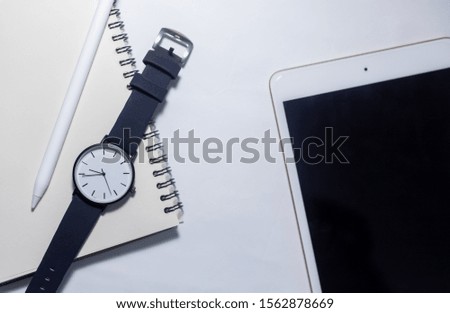Watch, smart phone, notebook, placed on a white background