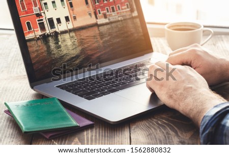 Man using laptop planning vacation. Travel and vacations concept 
