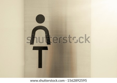Toilet symbol on the stainless steel surface