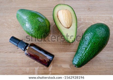 Green avocado on a wooden background. Exotic healthy fruit.