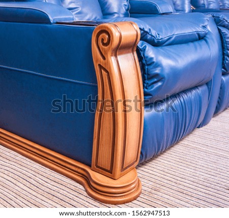 Blue leather sofa. Fragment. Furniture salon photography