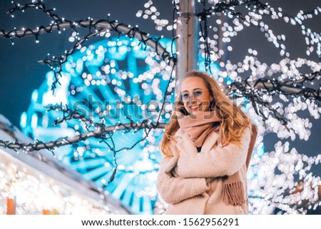 Girl posing against the background of decorated trees