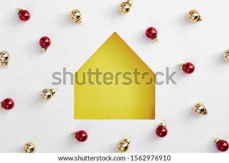 Christmas minimal concept - christmas house yellow silhouette with bauble pattern. Flat lat, top view. Merry christmas (xmas) background. Minimal idea concept. Simple shape.