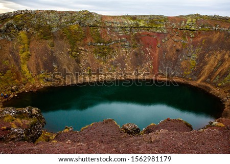 Kerid volcanic crater lake in Iceland. Landscape with red volcanic stones on the top of Kerid Crater with blue crater lake in Iceland. Beautiful landscape in Iceland.