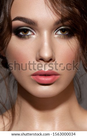 Close up portrait of an attractive female with a perfect skin, professional colorful make-up.