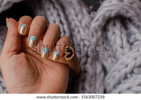 Women's hands with colorful pattern on the nails. Top view. Place for text. cozy winter style.