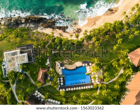 Luxurious hotel with a swimming pool at evening Sri Lanka, Drone photo