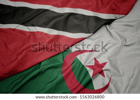 waving colorful flag of algeria and national flag of trinidad and tobago. macro