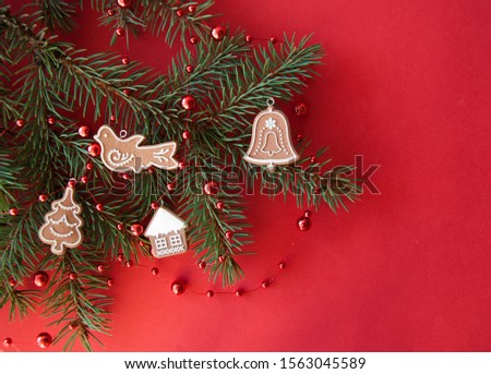 Christmas composition. Fir tree branches and decorations on red lay, top view, copy space