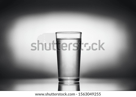one glass of water on a dark background