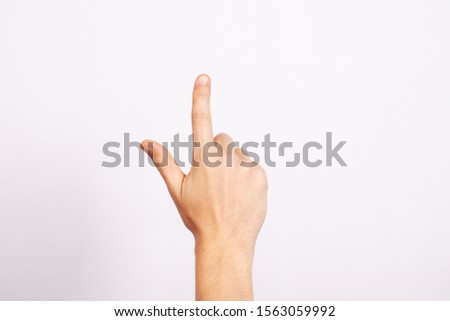 The man's hand isolated on white background. Gesture pointing, thumbs up, selection, pressing, indicating.