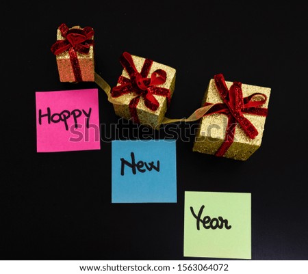 Writing Happy New Year on colorful sticky notes.