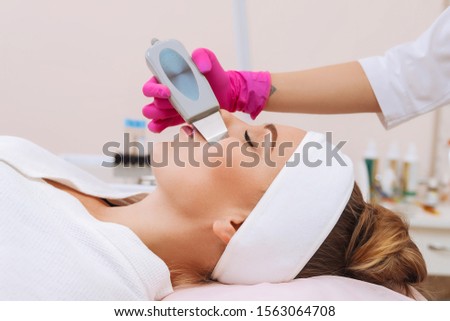 Skin Care. Close-up Of Beautiful Woman Receiving Ultrasound Cavitation Facial Peeling. Ultrasonic Skin Cleansing Procedure. Beauty Treatment. Cosmetology. Beauty Spa Salon. Royalty-Free Stock Photo #1563064708