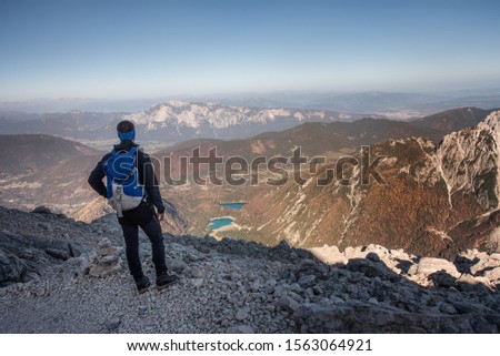 Hiker climbing mount Mangart in the Slovenian Julian Alps.