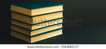 old books on black background close-up
