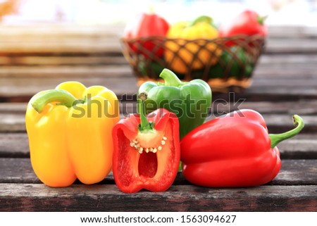 
Paprika in a basket of red, green, yellow on the old wooden floor Royalty-Free Stock Photo #1563094627