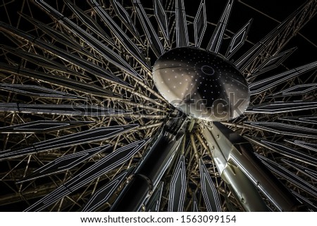 A beautiful closeup shot of Ferris wheel with lights at night time - great for a cool background