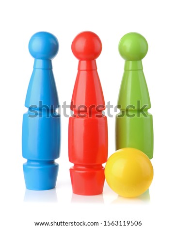 Front view of toy plastic bowling pins and ball isolated on white
