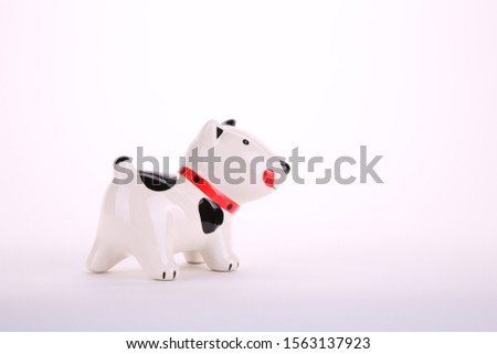 Dog dolls made of ceramic, on white background with copy space.