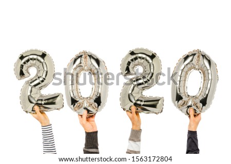 Hands holding balloons numbers 2020 on a white background. Concept new year, the onset of 2020, the year of the white rat