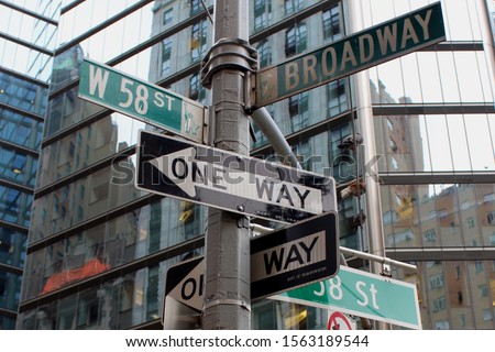Crowded street sign in Manhattan, New York City, including 58th street and Broadway.