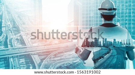 Future building construction engineering project concept with double exposure graphic design. Building engineer, architect people or construction worker working with modern civil equipment technology. Royalty-Free Stock Photo #1563191002