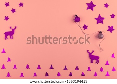 Christmas and New Year composition.  Balls, stars and fir-trees, magenta decorations on bright pink background.  Flat lay with copy space. Top view