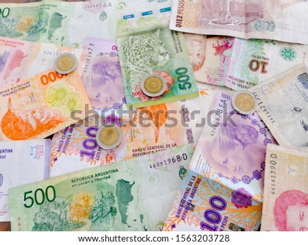 South America countries banknotes and coins for background. Argentine peso