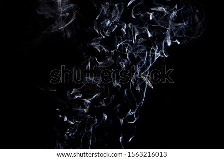 Smoke  on a black background, abstract photo with swirls in the air