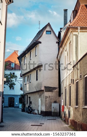 Narrow street with an interesting old house in Memmingen, Germany.