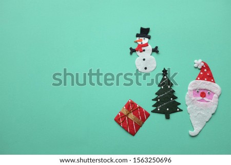 top view gift box, Santa Claus​ Christmas​ tree​ and​ Snowman​ decoration​ on​ the green background.concept Christmas and Happy new year concept