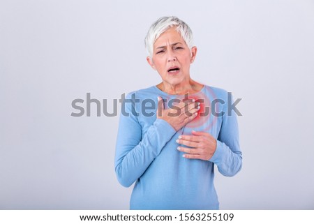 Woman having a pain in the heart area. Heart Attack. Painful Chest. Health Care, Medical Concept. High Resolution. Woman having heart attack at home