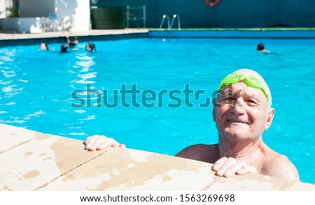 old man posing in swimming pool