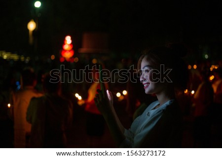 Asian woman using smart phone in outdoor at night
