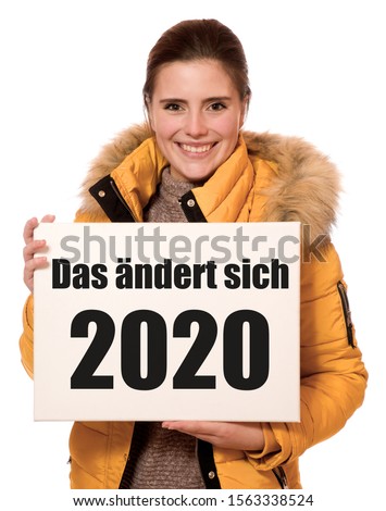 Woman holding a banner: Das ändert sich 2020 (in English: that will change in 2020)