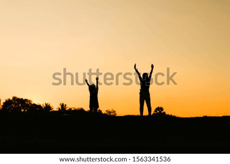 Children and women raise their hands Silhouette Sunset Evening