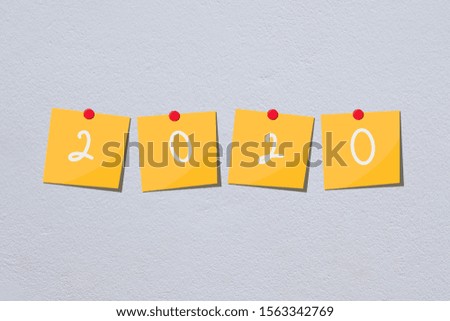 2020 happy new year yellow paper note on white wall 